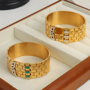 Golden watch-band style titanium bracelet with turquoise stones and inlaid crystals
