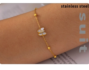 Detail of 18k gold butterfly bracelet with white mother-of-pearl and zircon inlay
