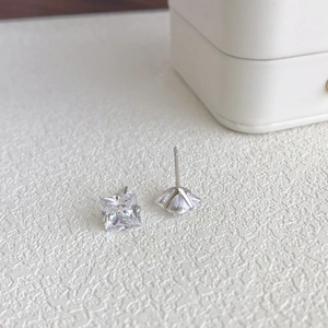 Macro detail of S925 sterling silver stud earrings with square-cut 5A zircon inlay