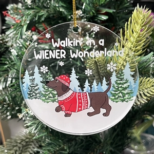 Acrylic Christmas ornament featuring a dachshund in a festive wreath with hanging cord