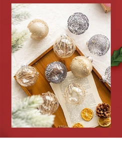 Close-up of assorted Christmas ornaments with gold glitter and pine cone accents