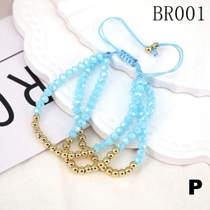 Detail of light blue crystal beads and gold metal beads on adjustable woven bracelet