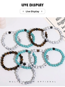Flat lay of beaded stretch bracelets in turquoise, tiger eye, and volcanic stone