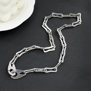 Detail of silver wavy link chain with oversized lobster clasp on black leather