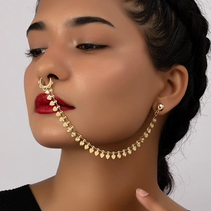 Golden heart nose-to-ear chain jewelry with minimalist aesthetic on a female model