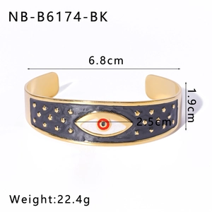 Macro detail of gold enamel evil eye bracelet with dimensions 6.8cm and 1.9cm