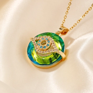 Vintage evil eye necklace featuring a gradient blue crystal pendant and gold chain
