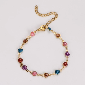 Detailed shot of golden link bracelet with thirteen multi-color glitter heart charms