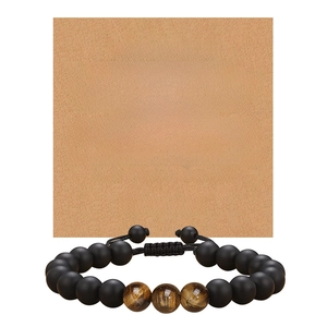 Detailed view of matte black and tiger eye bead bracelet with grandson greeting card