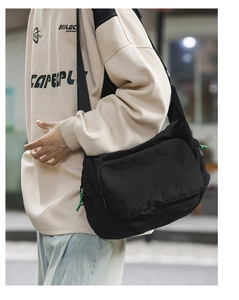 Detail of a large capacity waterproof nylon messenger bag with adjustable strap and side zipper