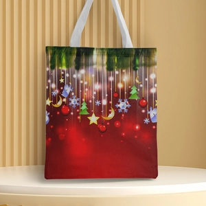 Detailed close-up of a red canvas Christmas tote bag featuring festive tree and star prints