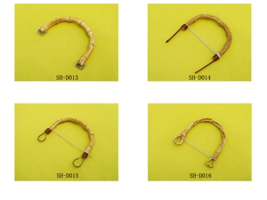Detail view of four bamboo handbag handles with metal rings and decorative beads