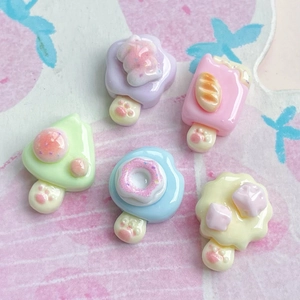 Detailed view of colorful resin cat paw donut and dessert charms for DIY handmade crafts