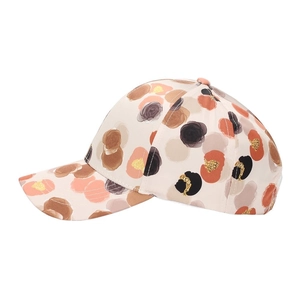 Side view of beige baseball cap with artistic watercolor floral print and gold glitter detail