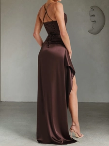 Detail of elegant backless satin evening dress with lace-up straps and high side slit
