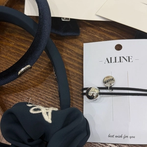Detail of navy velvet scrunchie with A embroidery and silver pendant hair accessories