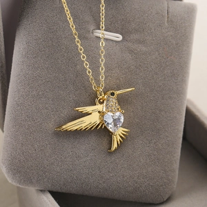 18K gold plated hummingbird necklace with heart shaped crystal and sparkling zircon accents