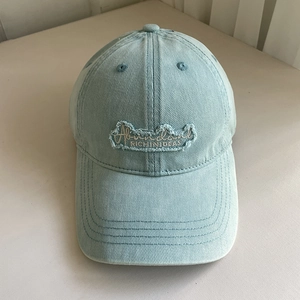 Detail of vintage washed blue baseball cap with Abundant RICH IN IDEAS embroidery