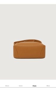 Detailed bottom view of large brown leather crossbody bag showing craftsmanship and texture