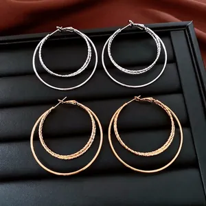 Boucles d'oreilles créoles doubles plaquées or 18k avec texture torsadée en or et argent