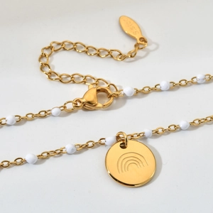 Gold stainless steel necklace featuring white beads and a rainbow engraved coin pendant
