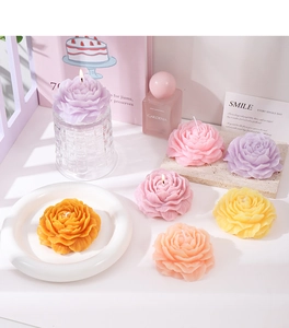 Macro detail of multicolored peony flower scented candles on a glass holder set