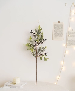 Artificial Christmas greenery branch with black and white berries for festive home decoration