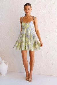 Detail of floral backless mini dress with layered ruffles and adjustable straps in light green