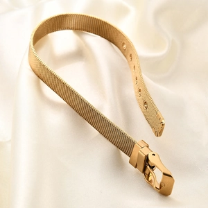 Detailed close-up of 10mm 18K gold mesh watch band with refined buckle on white silk fabric