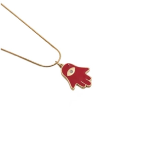 Detailed view of red enamel Hamsa hand pendant with crystal eye on gold snake chain