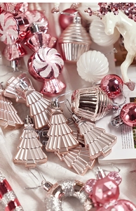 Detailed view of pink and white glittery Christmas ornaments in candy and animal shapes