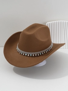 Close-up of brown western cowboy hat with rhinestone fringe and metallic studs detail