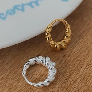 Close-up of S925 sterling silver twisted hoop earrings in gold and silver finishes