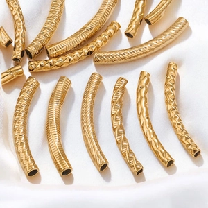 Macro shot of 18K gold plated textured curved tube beads for DIY jewelry making