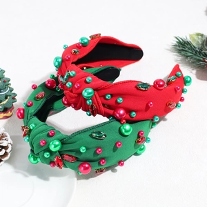 Christmas knotted headband detail showcasing festive red and green colors with pearls and crystals.