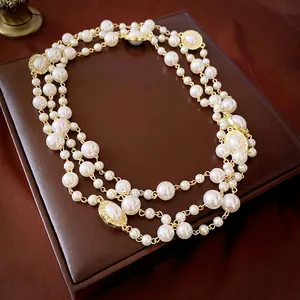 French style multi-layer pearl necklace with golden oval accents and sparkling crystals