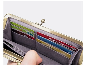 Detailed close-up of a vintage leather long wallet with card slots and metal frame