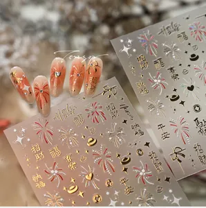 Macro shot of Lunar New Year nail art stickers featuring red fireworks and gold lucky charms