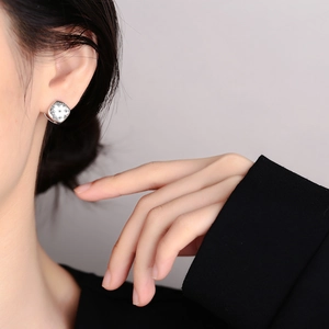 Chic silver square stud earrings with star-shaped zircon stones shown on a model