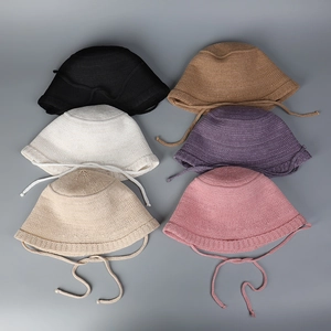 Detail of thin breathable knitted bucket hats showing six different color options and ties
