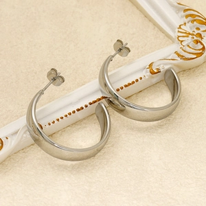 Polished silver stainless steel thick hoop earrings with a sleek minimalist modern design