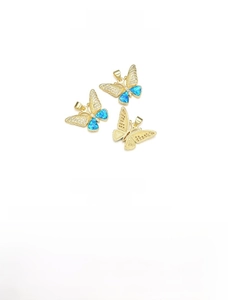 Macro detail of 18k gold plated butterfly pendant with blue opal and cubic zirconia
