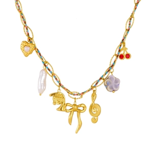 Gold charm necklace with colorful woven rope, musical notes and bowknot pendants