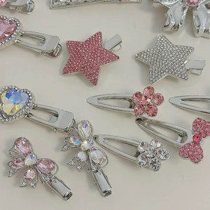 Pink rhinestone hair clip set with silver alloy heart star and bow designs on beige background