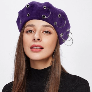 Detailed view of a purple wool beret featuring stylish silver metal ring ornaments