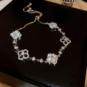 Detailed shot of adjustable floral bracelet with mother of pearl and zircon stones