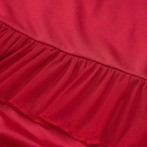 Detailed macro of red ruffled lettuce edge stitching with mesh and fabric patchwork texture