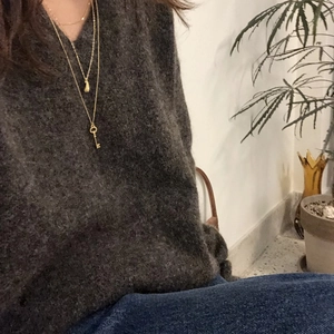 925 silver layered key and pod pendant necklace on gold chain with model view
