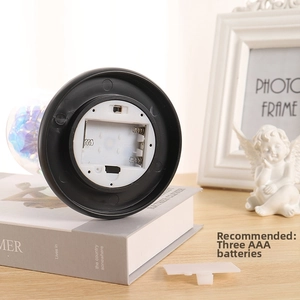 Detail view of the black round base showing AAA battery compartment and power switch