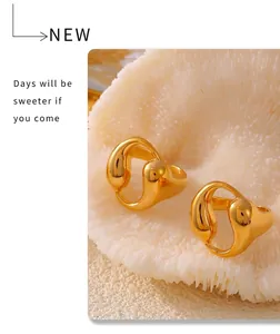 Macro detail of 18k gold plated liquid metal rings with organic water drop hollow design